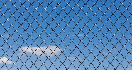 Fototapeta premium Metal mesh and sky