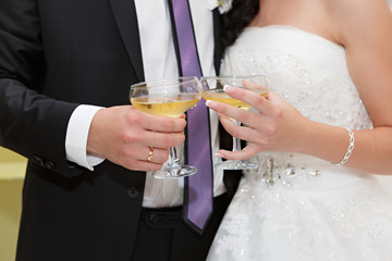 wine glasses in hand bride and groom