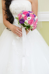 The bride at the wedding is holding a bouquet of flowers