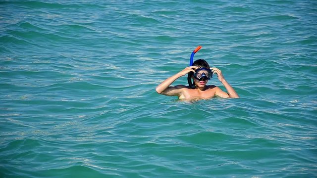 Boy with diving mask in the sea