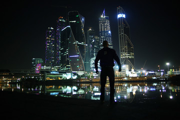 portrait of a man in a night cityscape skyscrapers lights