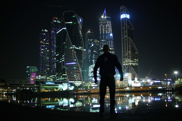 portrait of a man in a night cityscape skyscrapers lights