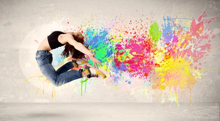 Gordijnen Happy teenager jumping with colorful ink splatter on urban backg © ra2 studio