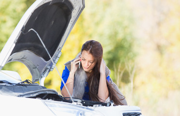 woman with a broken car