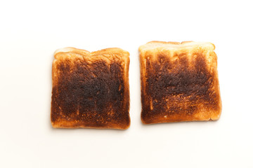 Two burnt slices of toasted bread