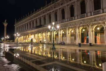 Fototapeta na wymiar San Marco square with reflection on water at night, Venice