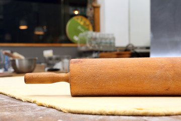 Roller and dough into the kitchen table ready for rolling