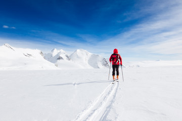 Mountaineer walking on a glacier during a high-altitude winter e
