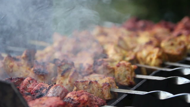 meat on skewers with smoke. 2 shots