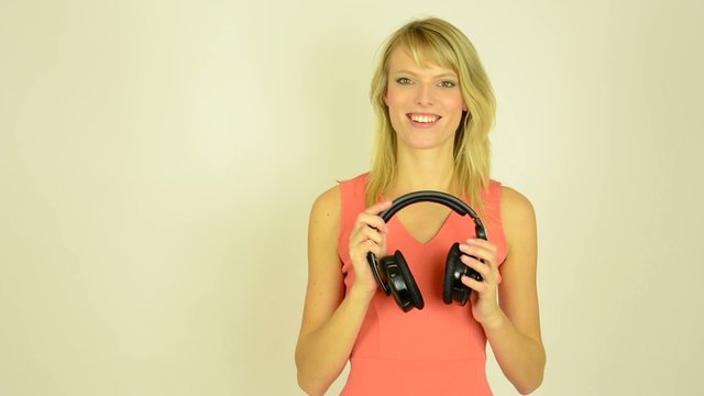 woman listens music with headphones - woman takes off headphone