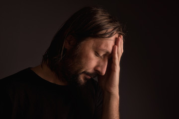 Bearded adult man with migraine headache