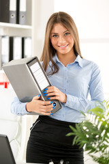 Young Businesswoman With Binder