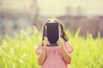Happy Girl Playing Outdoor With Tablet