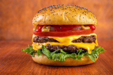 Double cheeseburger , red wooden background - 73252209