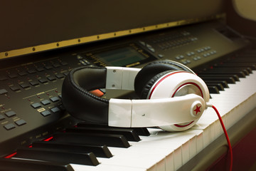 Piano keyboard and headphones