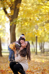 Fototapeta premium mother and the kid walk in autumn park