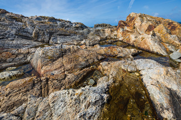 Colored granite and schist rock face