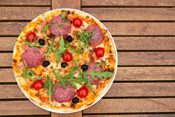 Delicious italian pizza served on wooden table