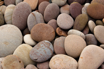 Fototapeta na wymiar Rounded pebbles at the beach