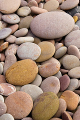 Fototapeta na wymiar Rounded pebbles at the beach