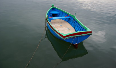Fototapeta na wymiar Rain ,silence and a lonely boat