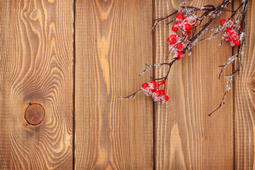 Christmas wooden background with holly berry branch