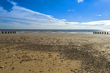 Empty beach under blue sky at seaside