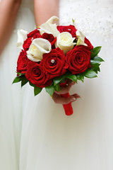 The bride at the wedding is holding a bouquet of flowers