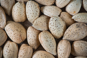 Whole almonds on wooden table