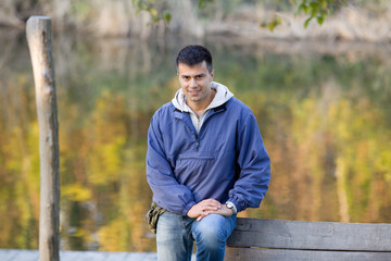 Handsome guy standing next to river