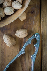 Top view over whole almonds and crusher
