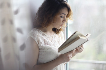 girl reading at the window