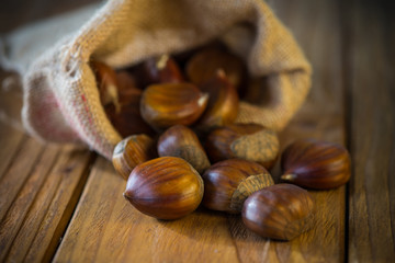 Fresh oraganic chestnut in sack on table
