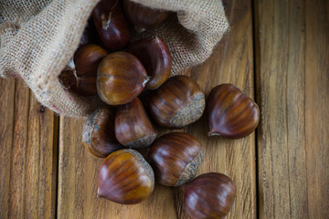 Fresh oraganic chestnut in sack on table