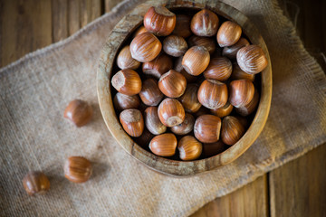 Hazelnuts in vintage bowl on table