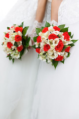 The bride at the wedding is holding a bouquet of flowers