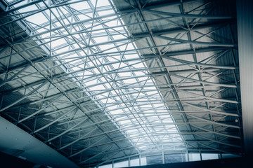 Big metal roof with panoramic windows at airport terminal