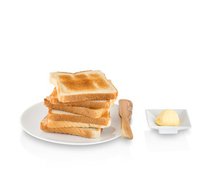 Stack of toasts with butter on white background.