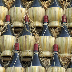 arranged many chianti wine bottles - obrazy, fototapety, plakaty