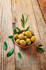 Olives on rustic table in a bowl