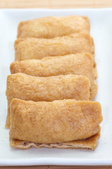 sushi flavored boiled rice wrapped in fried tofu