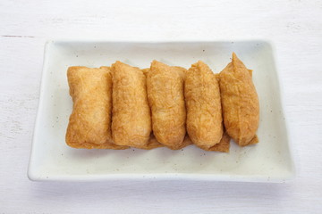 sushi flavored boiled rice wrapped in fried tofu