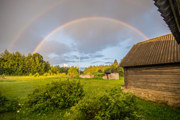 Double rainbow, summer field landscape