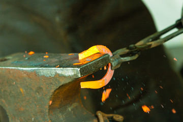 Hammering glowing steel - to strike while the iron is hot.