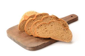 sliced loaf of bread on a cutting board isolated on white