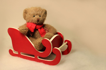 Teddy Bear Sitting in a Little Red Sled