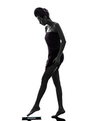 Fototapeta premium beautiful asian young woman wrapped towel standing weight scale