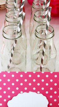 Bottles with grey and white striped straws