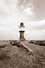 Lighthouse on the sea. Sepia