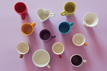 Background with colorful empty coffee cups. View from above